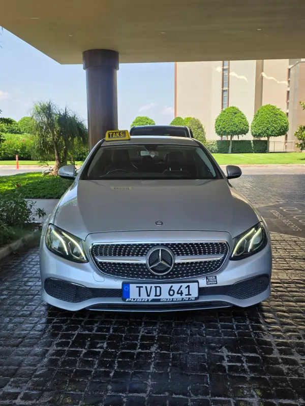 Mercedes taxi waiting at a hotel entrance for a transfer